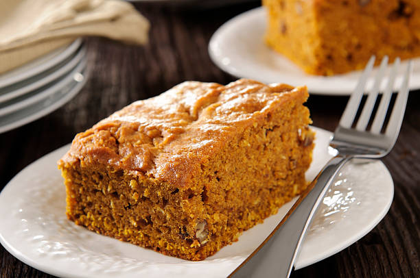 Fall Baking - Slice of pumpkin,pecan, and coconut cake with ingredients.