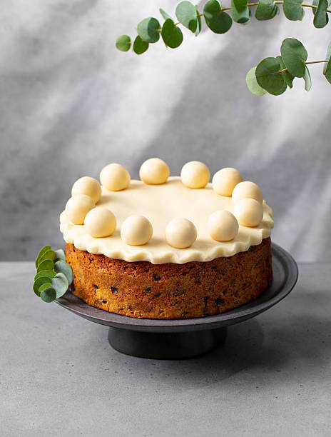 Easter simnel cake on a cake stand. Grey background. Copy space.