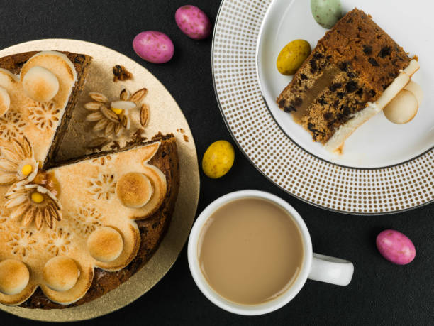 Easter Simnel Cake With Marzipan Icing and Decorations Against a Black Background